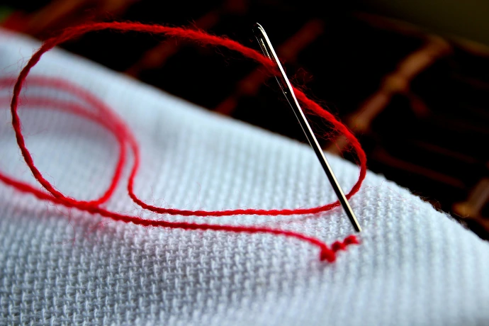 a close up of a piece of cloth with a needle